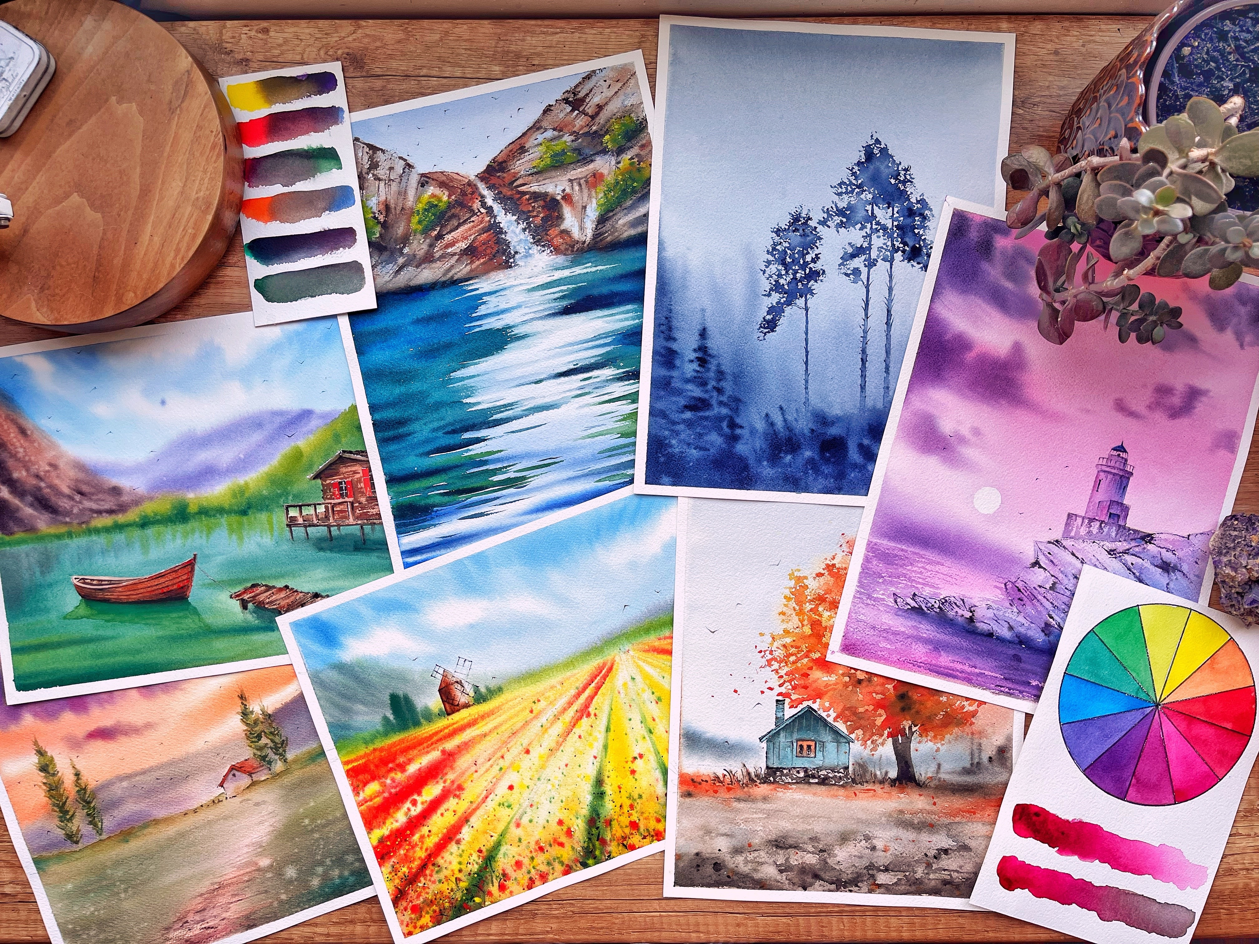 An aesthetic flatlay with dreamy watercolor landscapes