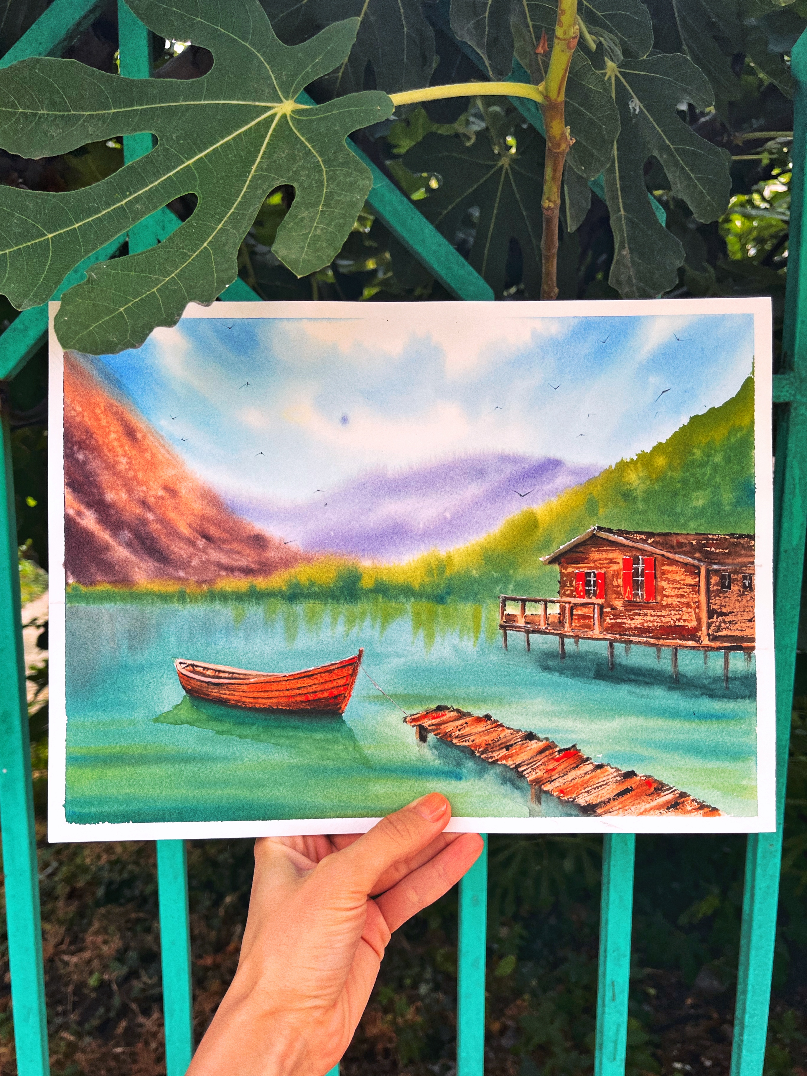 Peaceful watercolor landscape with a lake, a boat and a cabin