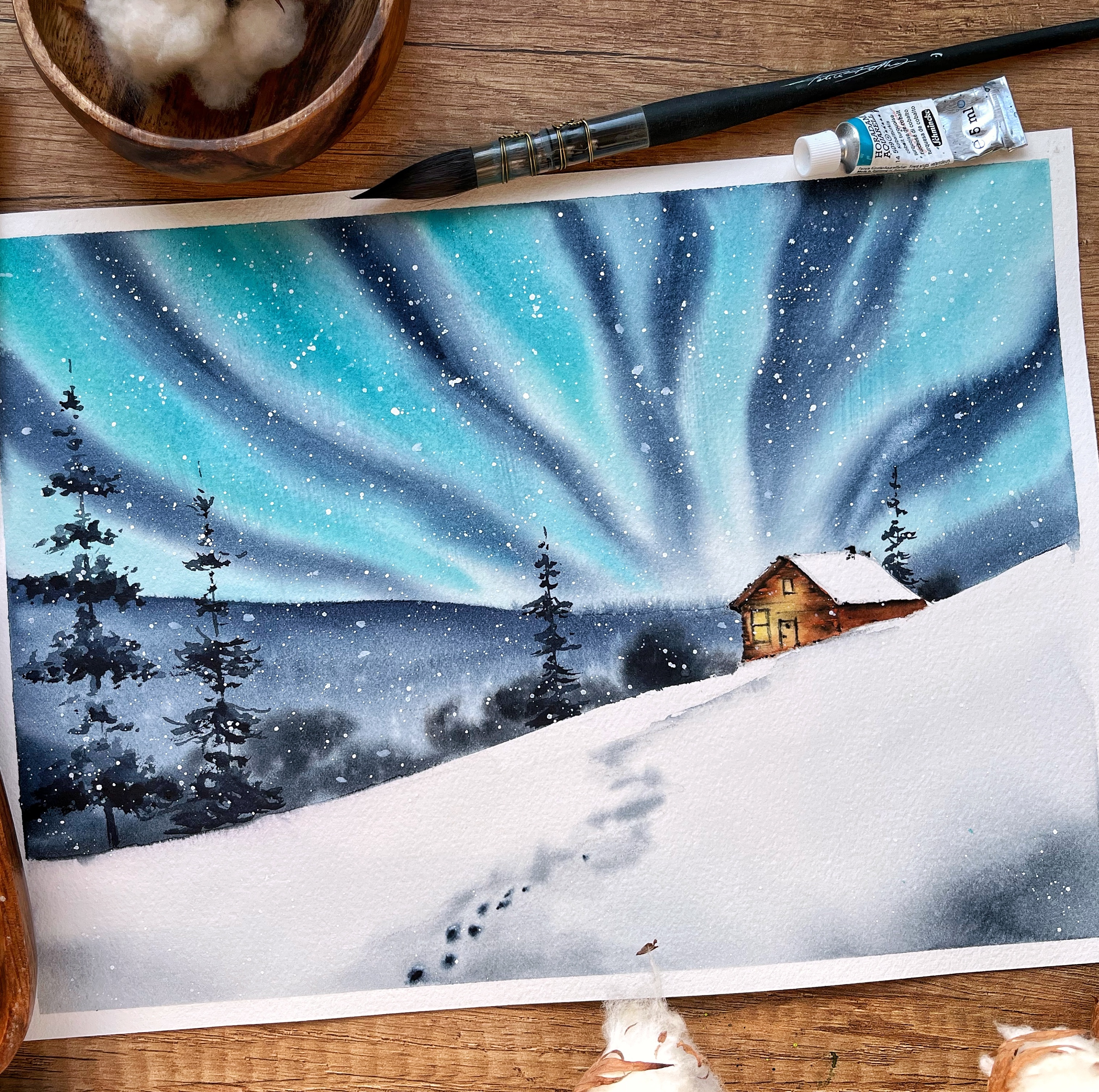 Watercolor landscape snowy winter night with northern lights and a cozy cabin